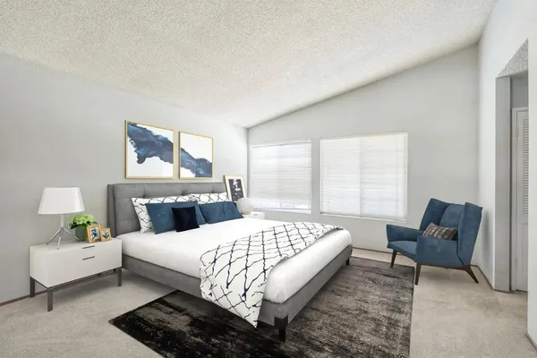 a bedroom with a bed and a couch