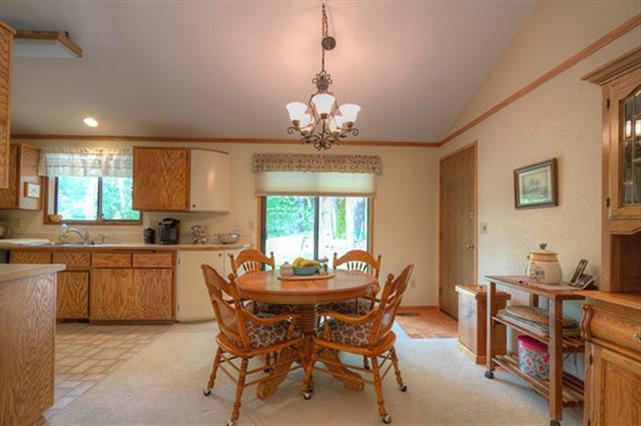 7192 Lower River Road Grants Pass, OR 97526 - Photo 5 of 30 a dining room with furniture a chandelier and window