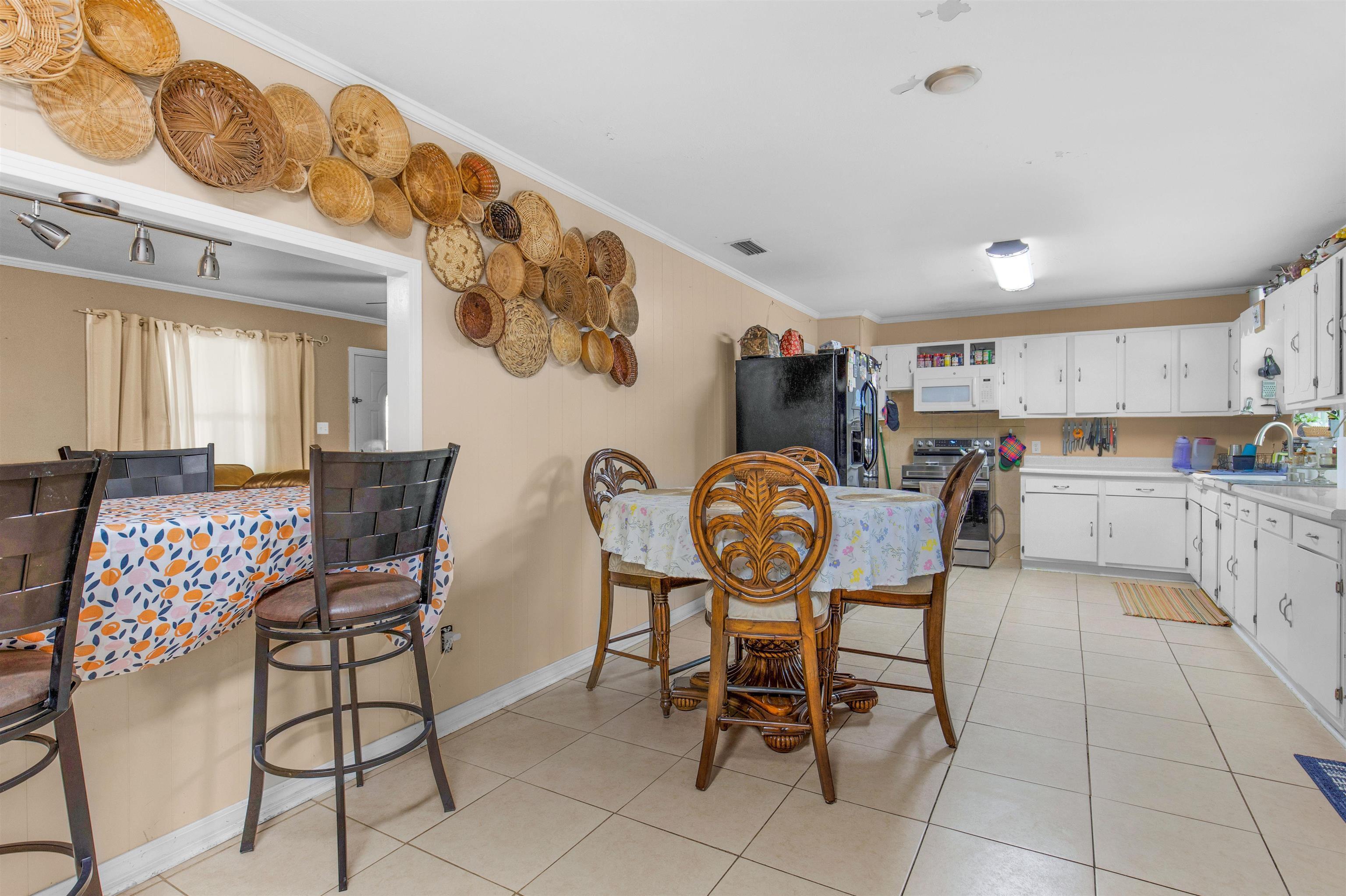 1147 Mack Pond Road Atmore, AL 36502 - Photo 5 of 40 Tiled dining room with crown molding and sink