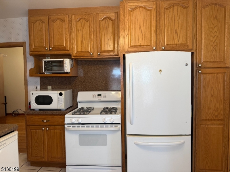 72 Baldwin Place, Unit 2 Bloomfield, NJ 07003 - Photo 3 of 24 a kitchen with a stove and a refrigerator