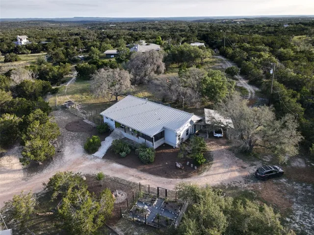 an aerial view of a house with a yard