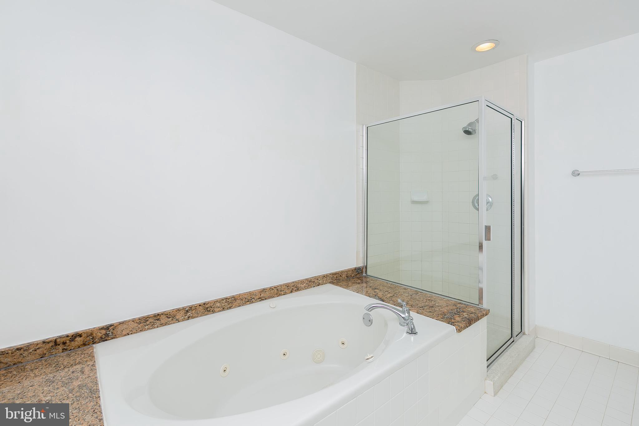 100 Harborview Drive, Unit 513 Baltimore, MD 21230 - Photo 19 of 58 a bathroom with a bathtub and a shower