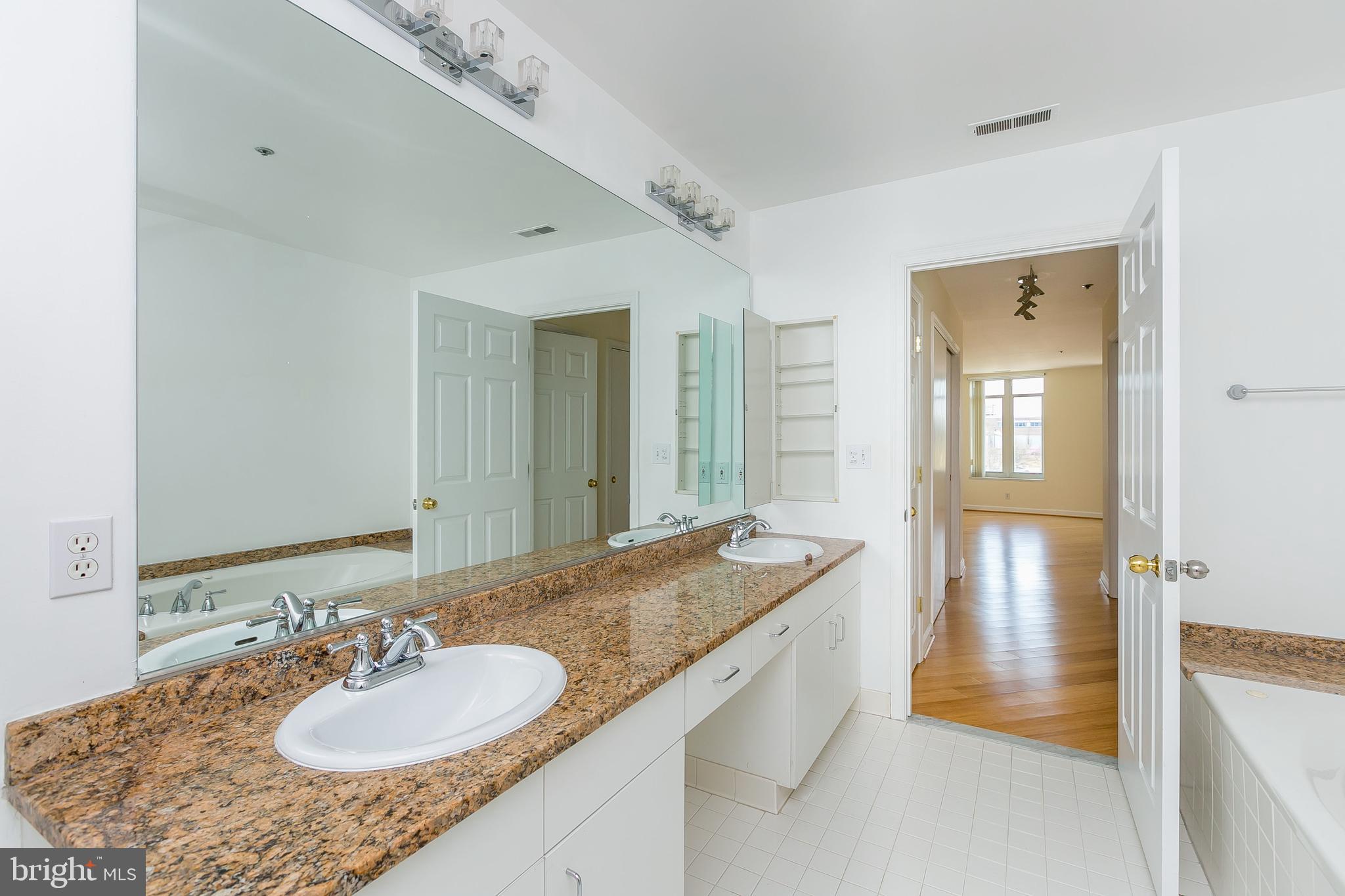100 Harborview Drive, Unit 513 Baltimore, MD 21230 - Photo 21 of 58 a bathroom with a granite countertop sink and a mirror