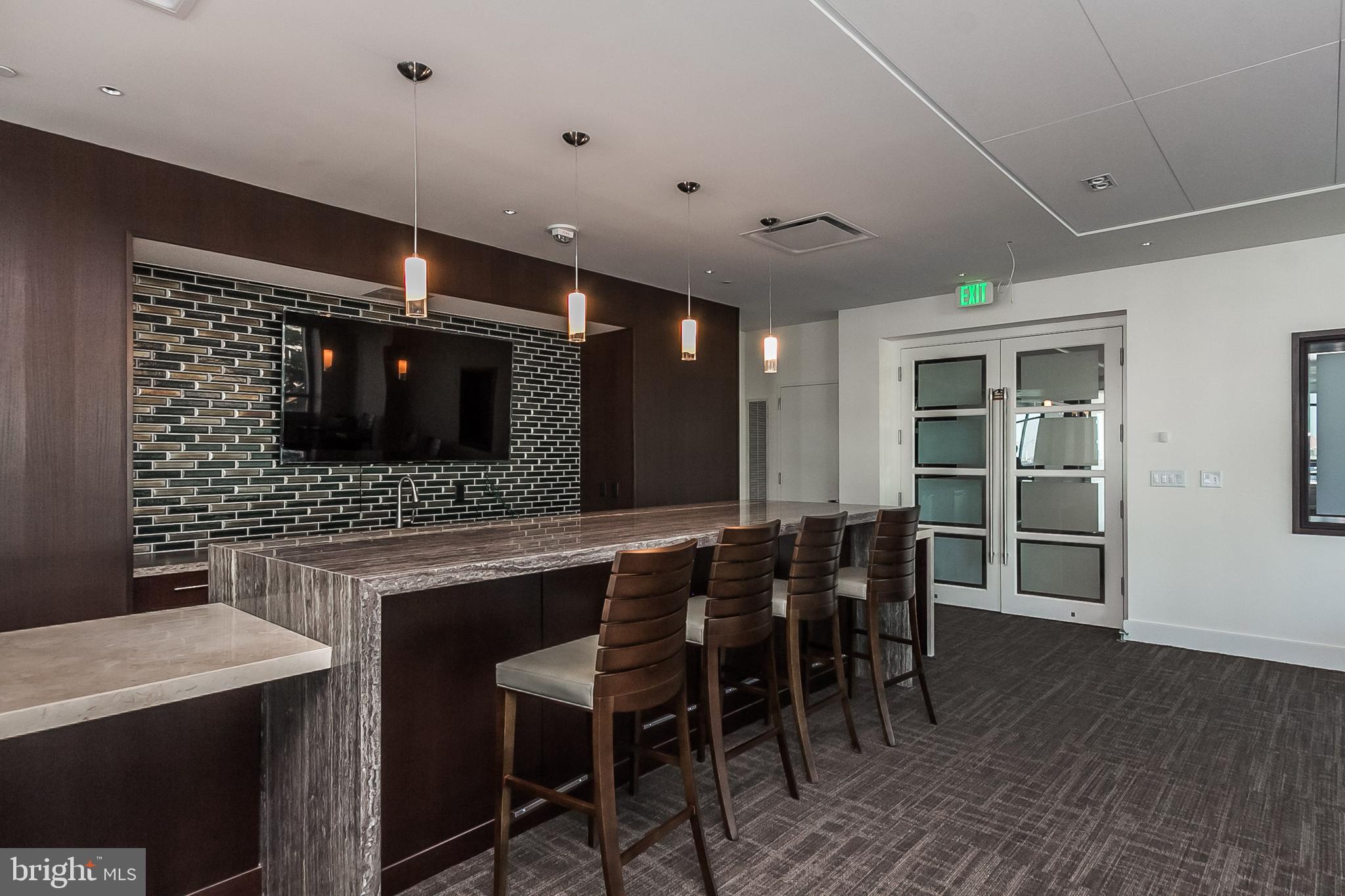 100 Harborview Drive, Unit 513 Baltimore, MD 21230 - Photo 40 of 58 a kitchen with a table and chairs in it
