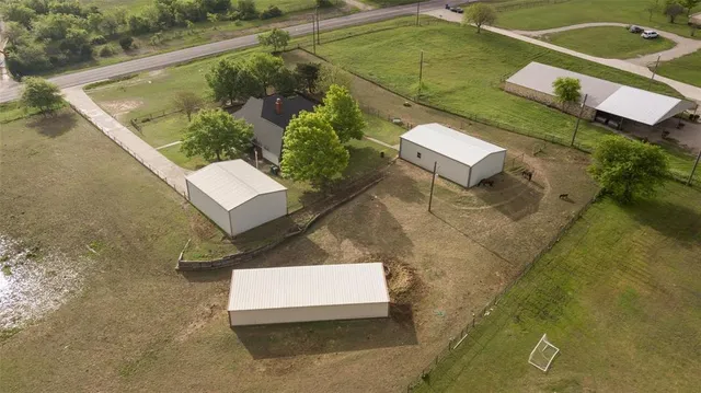 an aerial view of a residential houses with outdoor space
