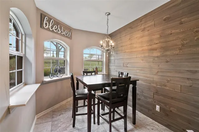 a view of a dining room with furniture and chandelier