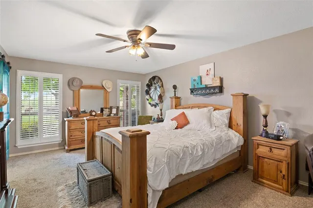 a bedroom with a large bed and a chandelier