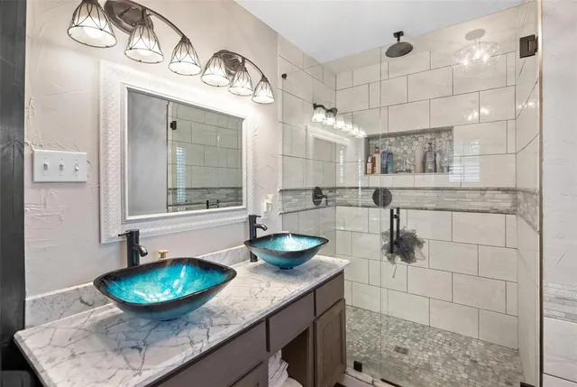a bathroom with a granite countertop sink a toilet and mirror