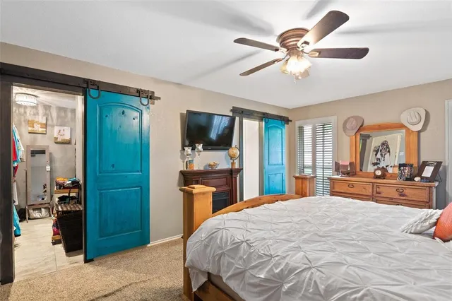 a bedroom with a bed and a large mirror with a flat tv screen