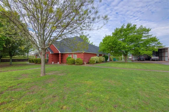 a house with huge green field in front of it