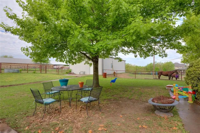 a view of a chair and table in the garden