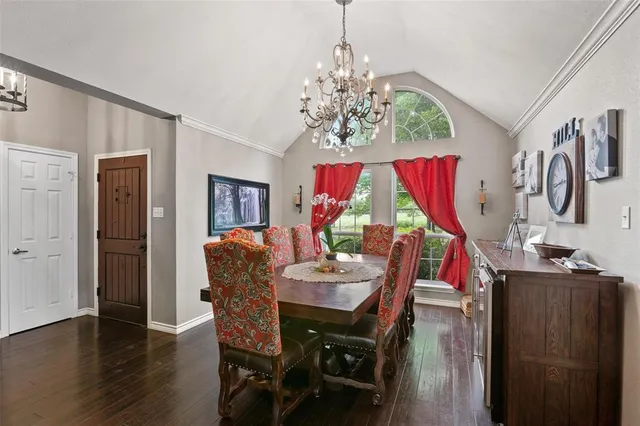 a view of a dining room with furniture wooden floor and chandelier