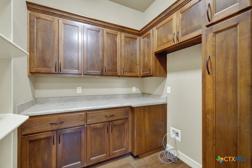 7607 Sky Loop Garden Ridge, TX 78266 - Photo 13 of 43 a kitchen with stainless steel appliances granite countertop a refrigerator and a sink