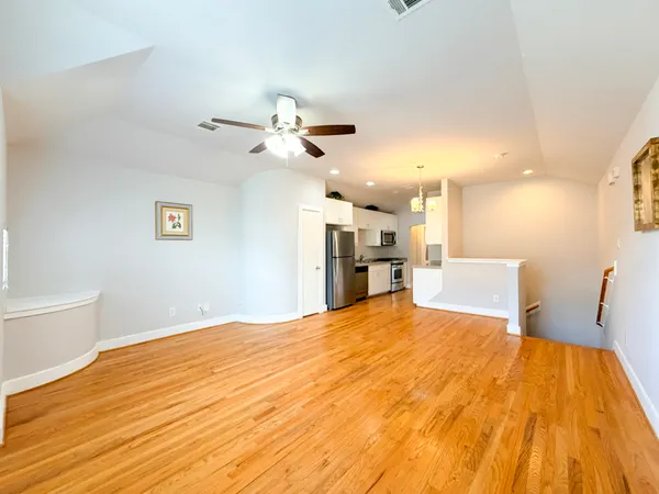 a large room with a bed and a chandelier