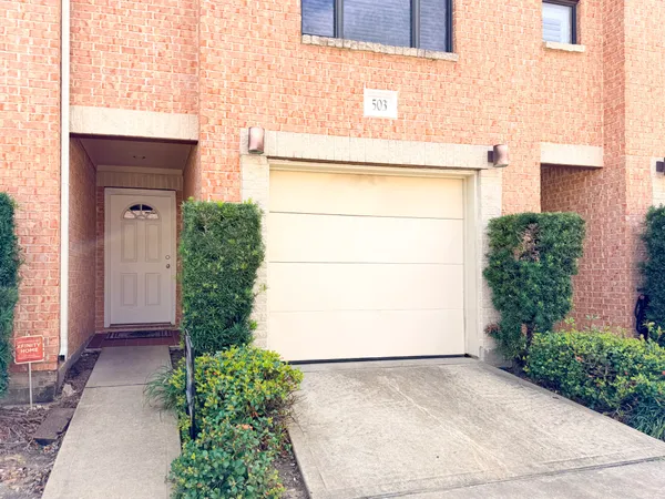 a view of entrance gate of house and car parked