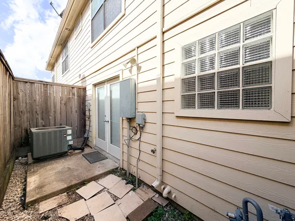 a view of a backyard with chair and wooden fence