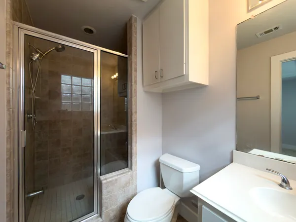 a bathroom with a toilet sink and shower