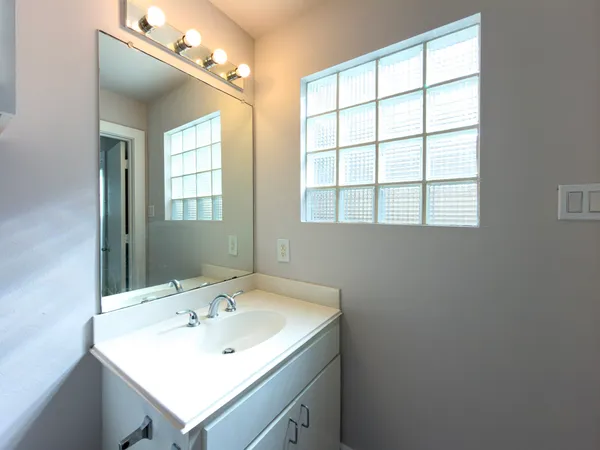 a bathroom with a sink and a window