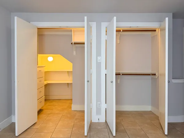 a view of a hallway with wooden shelves