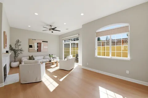 a living room with furniture fireplace and a potted plant