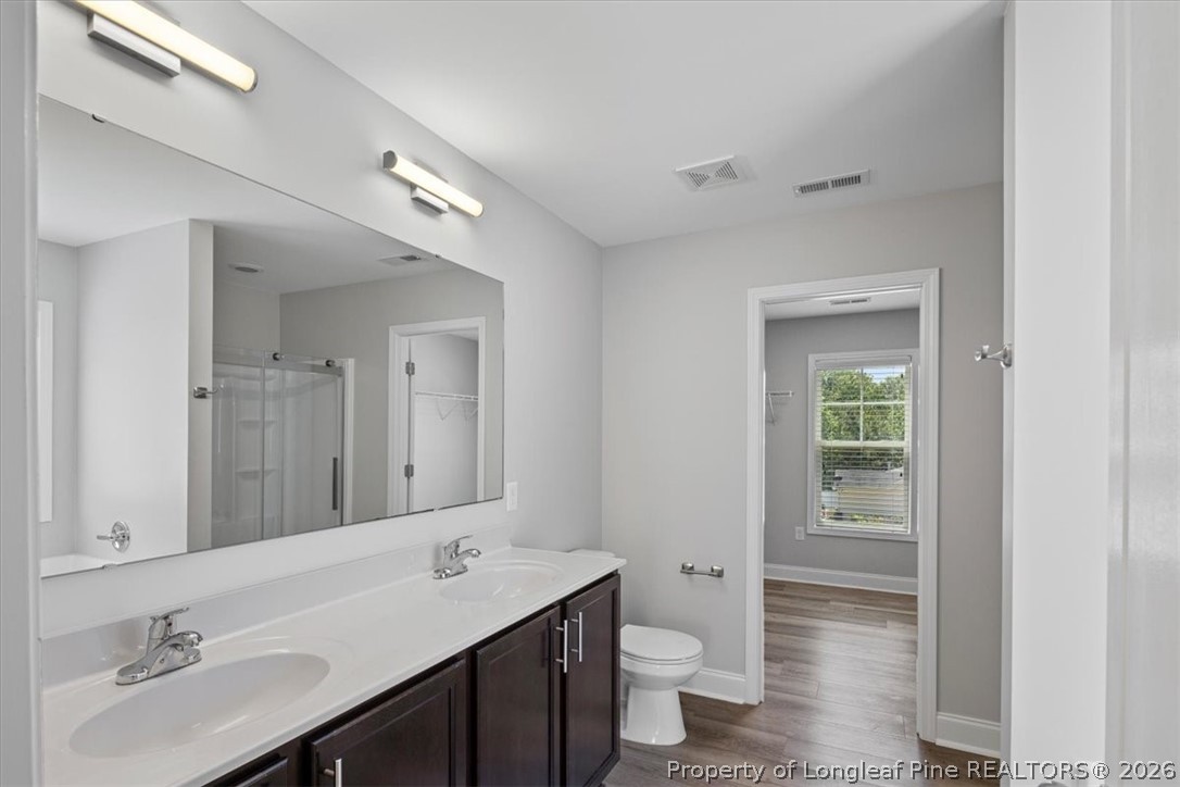 134 Huzzas Circle Cameron, NC 28326 - Photo 19 of 31 a bathroom with a granite countertop sink and a mirror