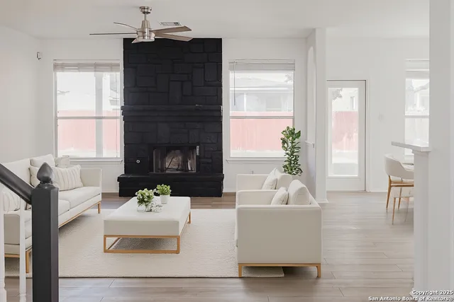 a living room with furniture and a fireplace