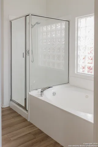 a bathroom with a tub and a shower