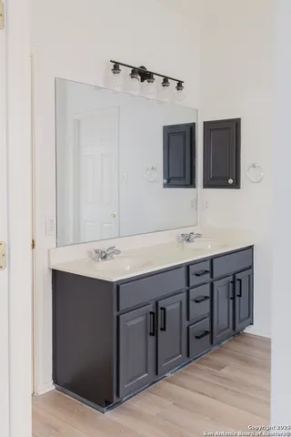 a bathroom with a double vanity sink and mirror