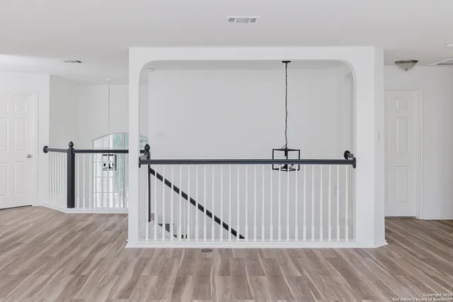 a view of hallway with wooden floor