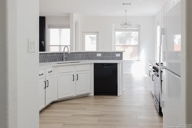 a spacious bathroom with a granite countertop sink a toilet a mirror and window