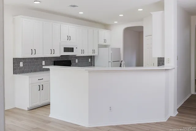 a kitchen with cabinets and stainless steel appliances