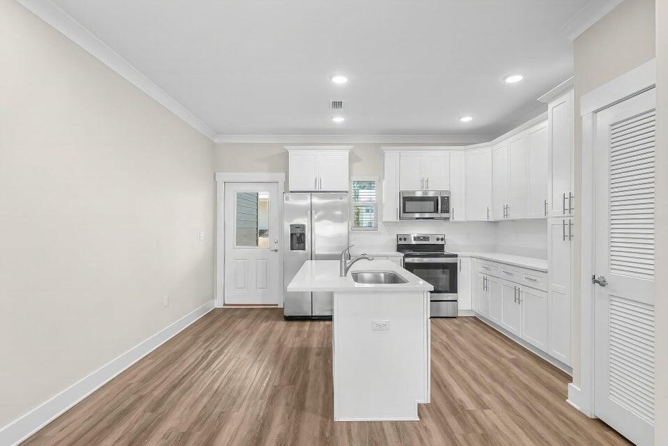306 North Sand Palm Road, Unit VISTA Freeport, FL 32439 - Photo 9 of 44 a kitchen with sink a microwave and cabinets