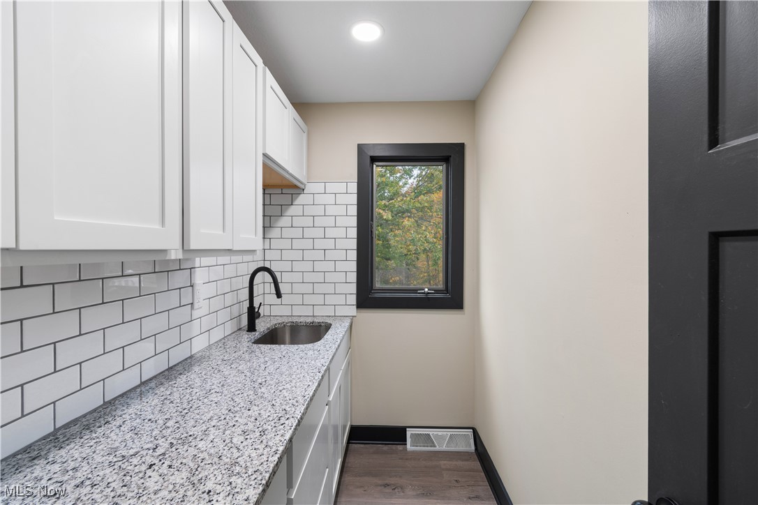 2201 Ridgewood Road Medina, OH 44256 - Photo 16 of 50 Laundry area featuring baseboards and dark wood finished floors