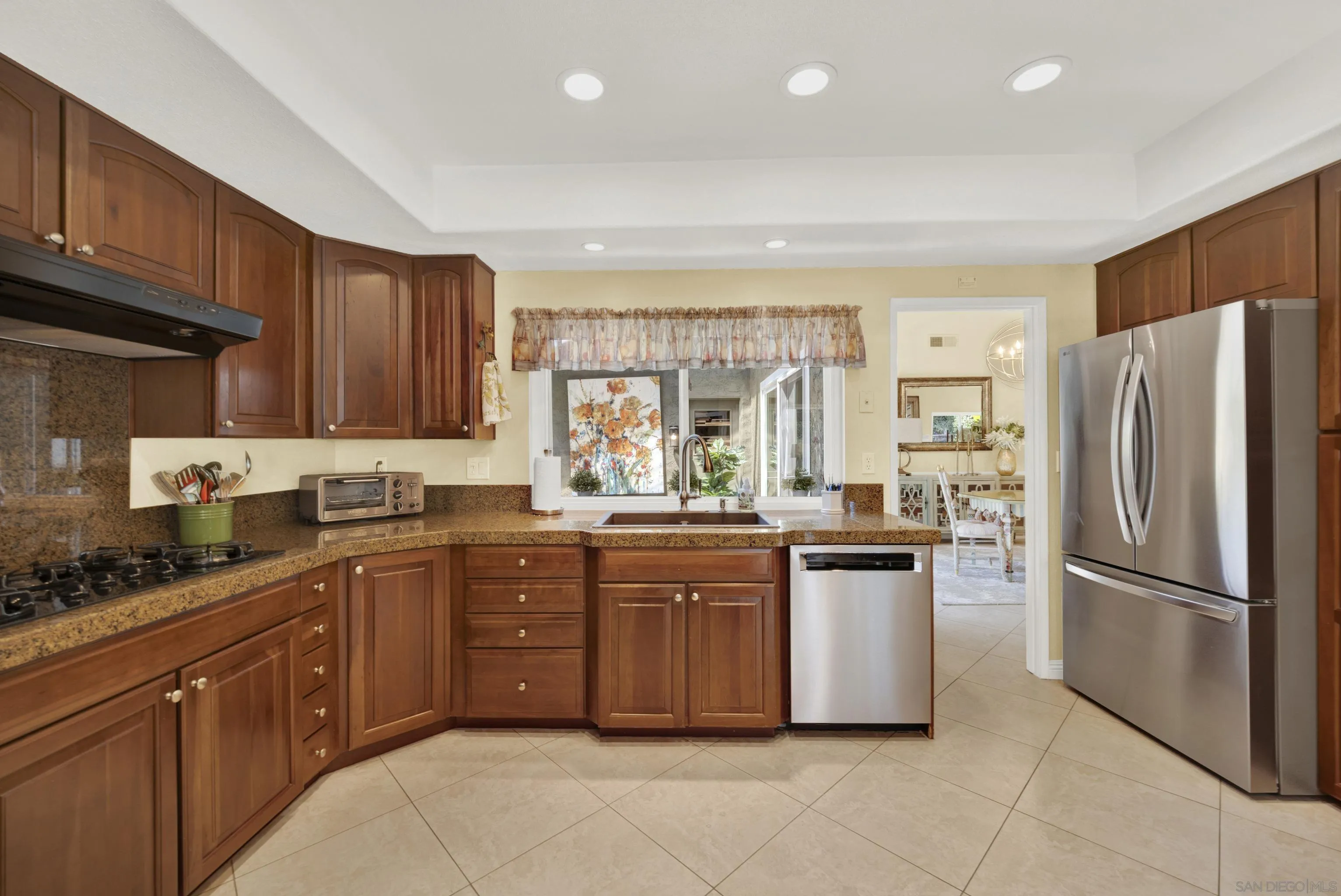 17233 Cuvee Court Poway, CA 92064 - Photo 13 of 53 a kitchen with stainless steel appliances granite countertop a refrigerator and sink