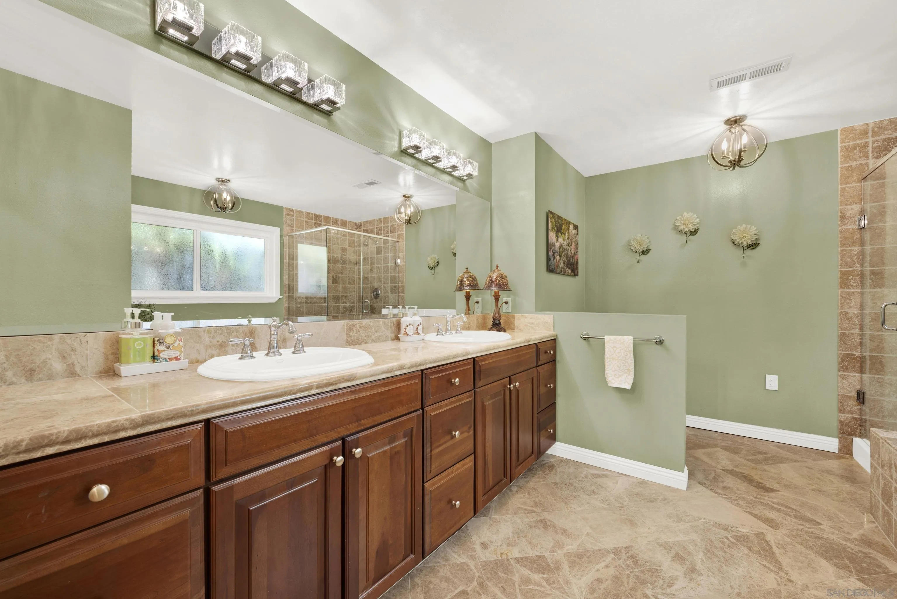 17233 Cuvee Court Poway, CA 92064 - Photo 25 of 53 a spacious bathroom with a double vanity sink a large mirror and a shower