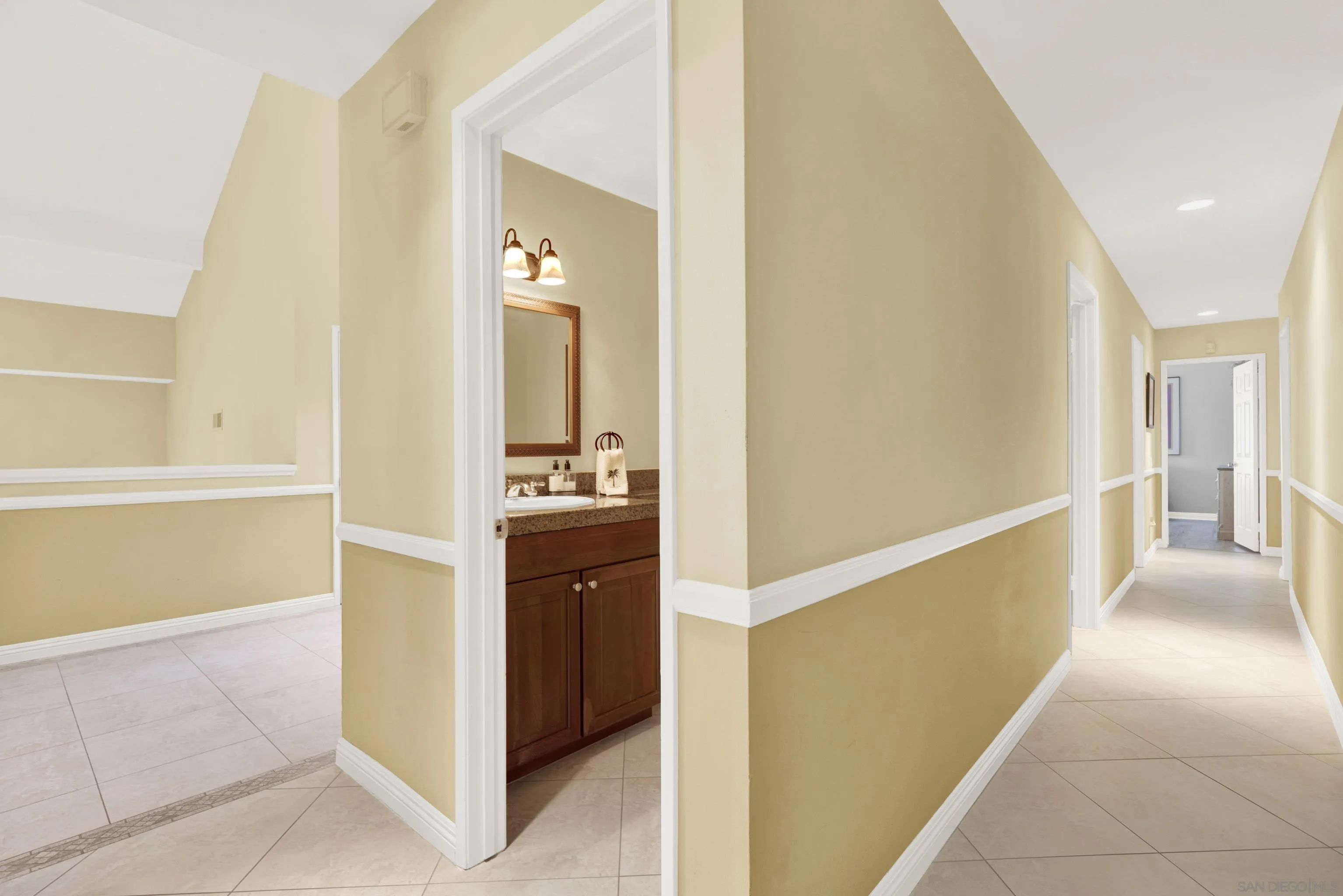 17233 Cuvee Court Poway, CA 92064 - Photo 31 of 53 a view of a hallway with dining area and chandelier