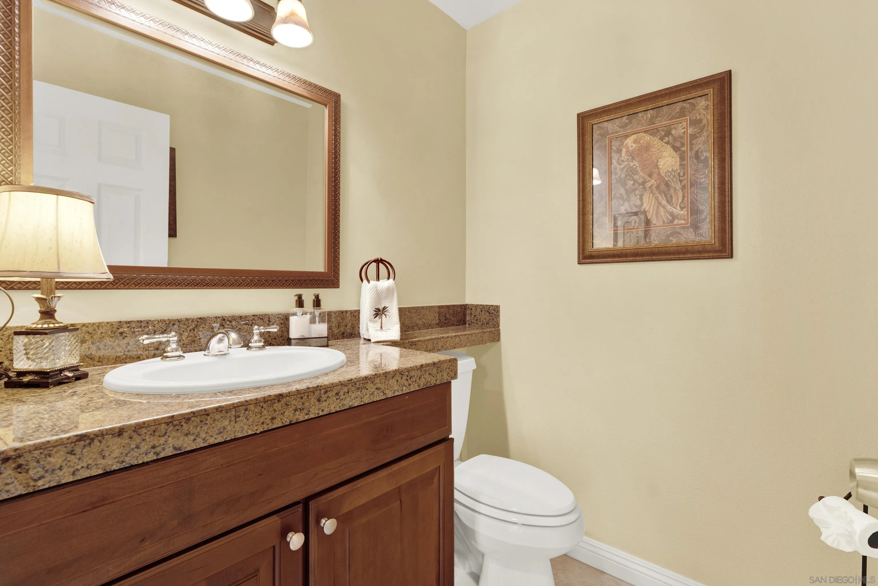 17233 Cuvee Court Poway, CA 92064 - Photo 32 of 53 a bathroom with a granite countertop sink mirror vanity and toilet