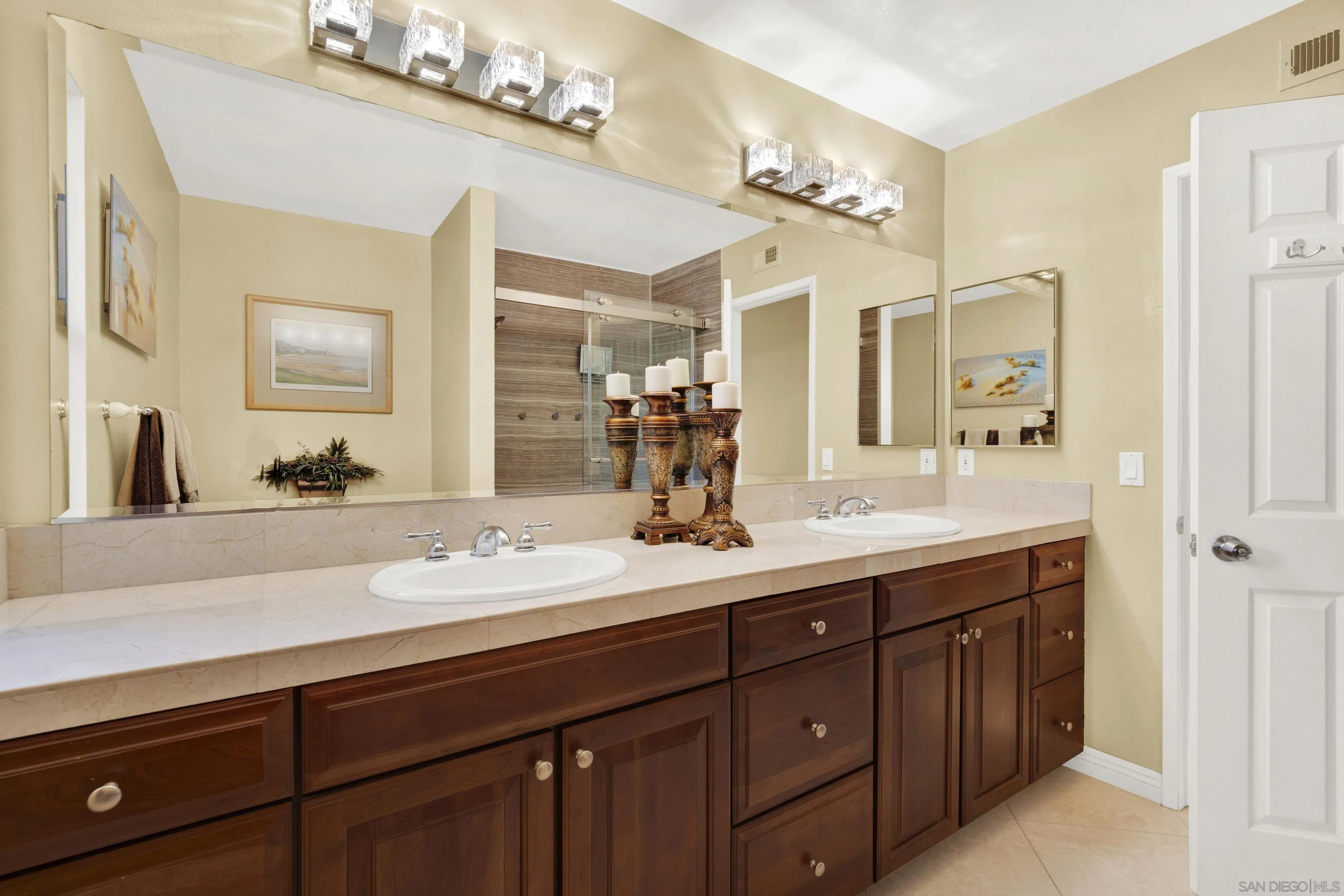 17233 Cuvee Court Poway, CA 92064 - Photo 37 of 53 a bathroom with a double vanity sink a mirror and a shower