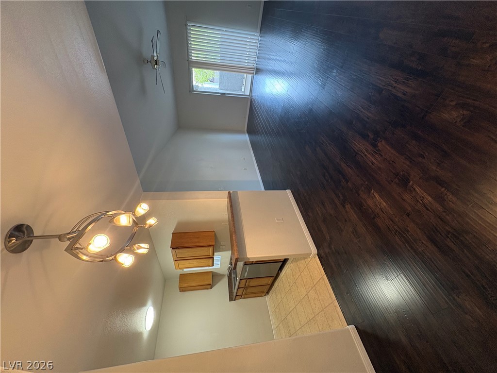 7255 West Sunset Road, Unit 2023 Las Vegas, NV 89113 - Photo 3 of 24 Rich dark wood floors anchor an open layout with a versatile breakfast bar.