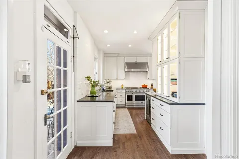 a kitchen with stainless steel appliances a sink and a refrigerator
