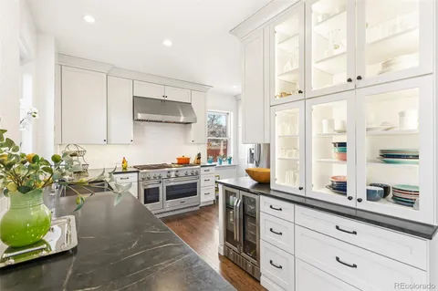 a kitchen with stainless steel appliances a stove a sink and a refrigerator