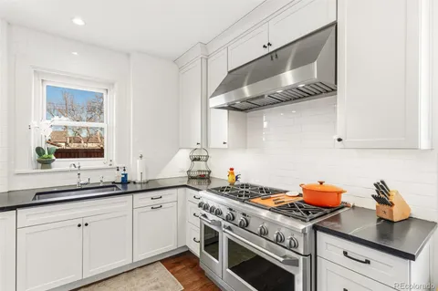 a kitchen with cabinets and stainless steel appliances