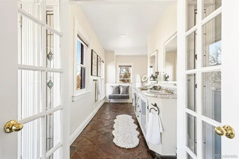 a spacious bathroom with sinks mirror and a bathtub