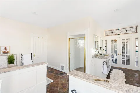 a bathroom with a bathtub and a window