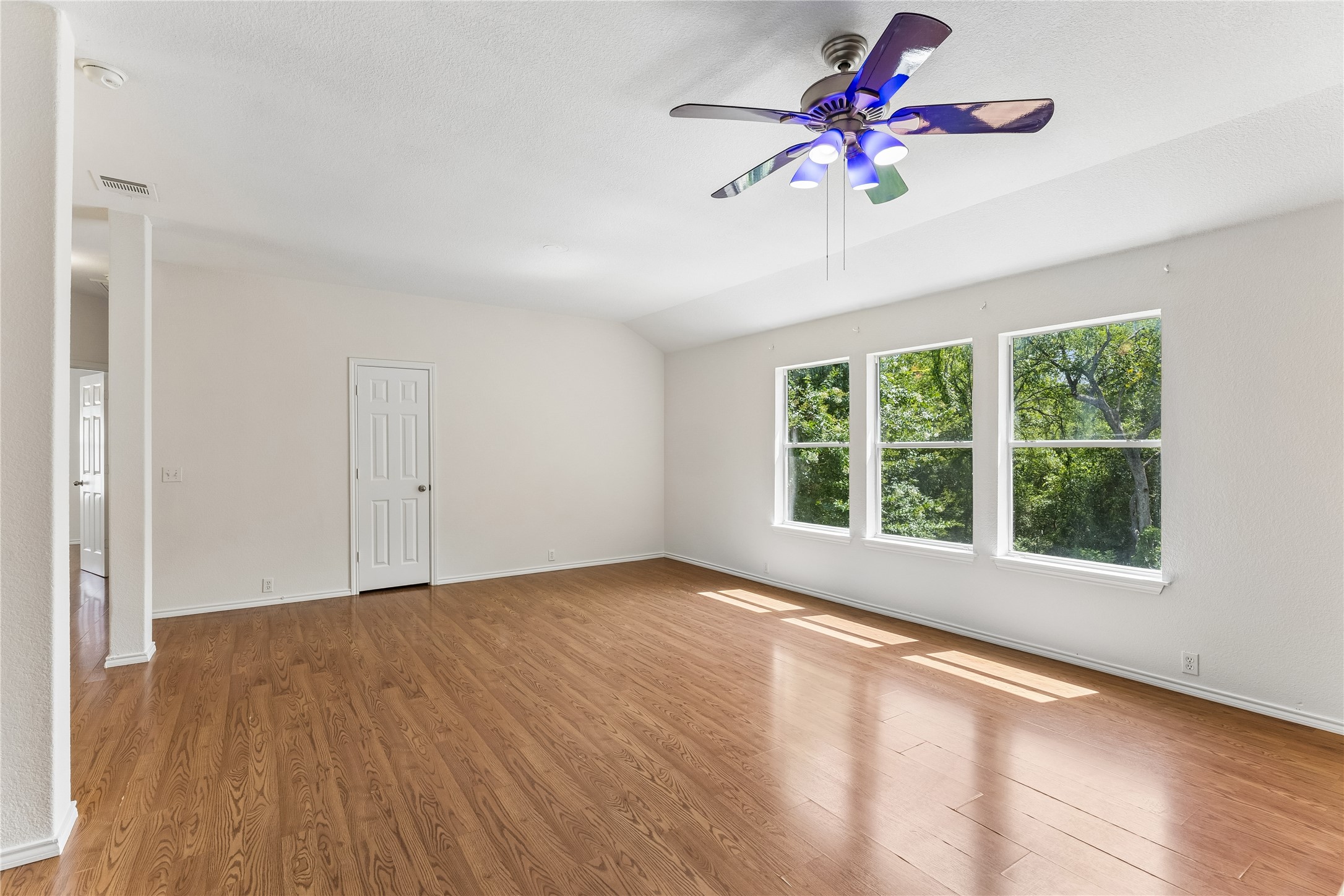 2372 Paradise Ridge Drive Round Rock, TX 78665 - Photo 28 of 40 Luminous living space featuring polished hardwood floors and verdant outdoor views.