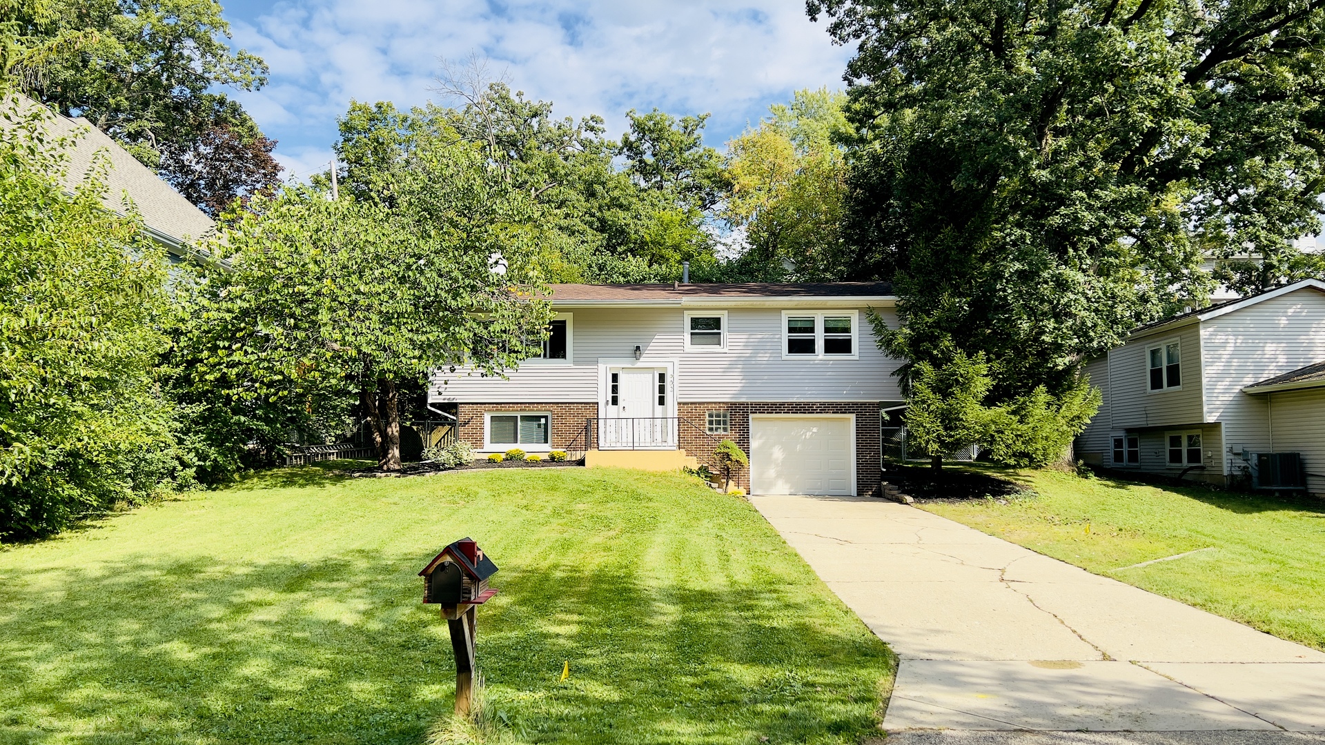 902 Woodland Road Wauconda, IL 60084 - Photo 2 of 28 a front view of a house with garden