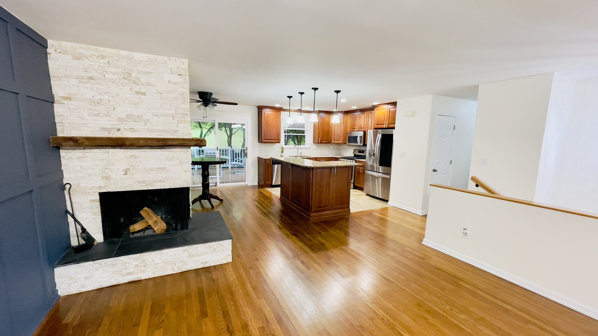 902 Woodland Road Wauconda, IL 60084 - Photo 6 of 28 a living room with stainless steel appliances furniture a fireplace and wooden floor
