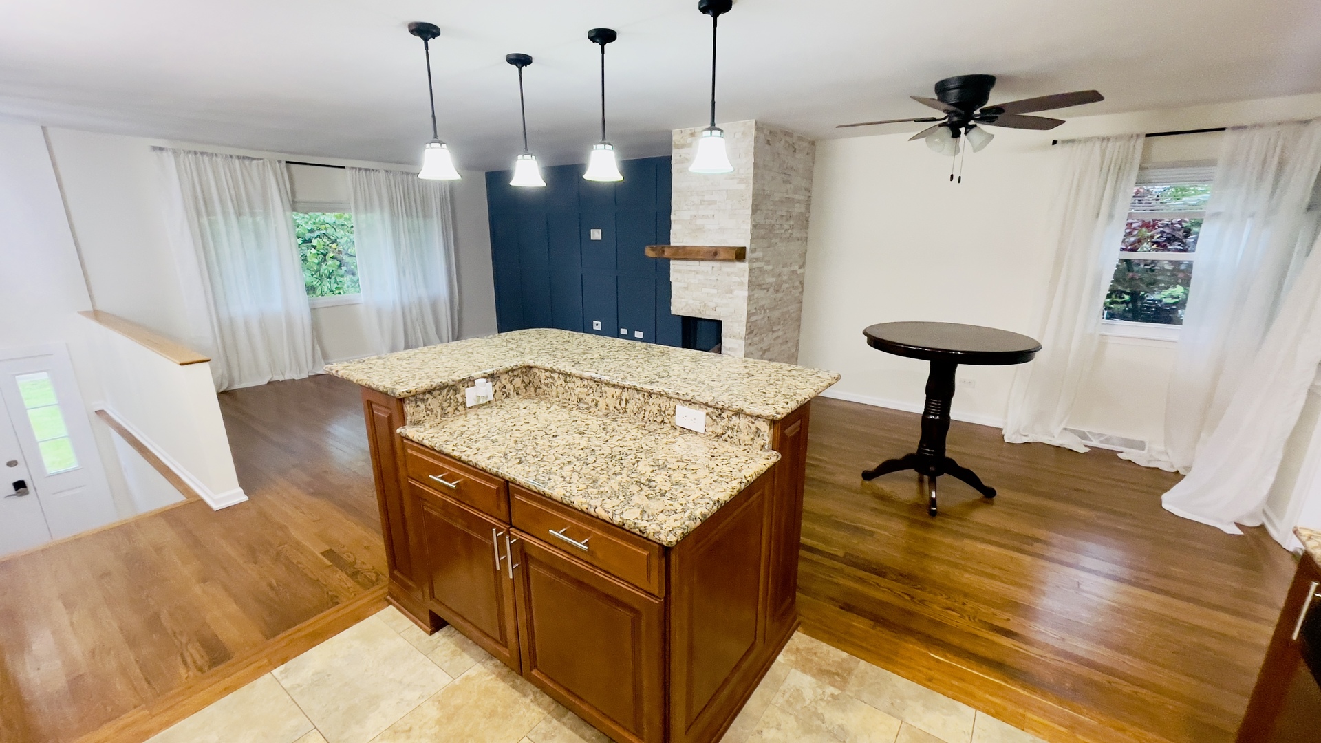 902 Woodland Road Wauconda, IL 60084 - Photo 8 of 28 a living room with a table and a fireplace