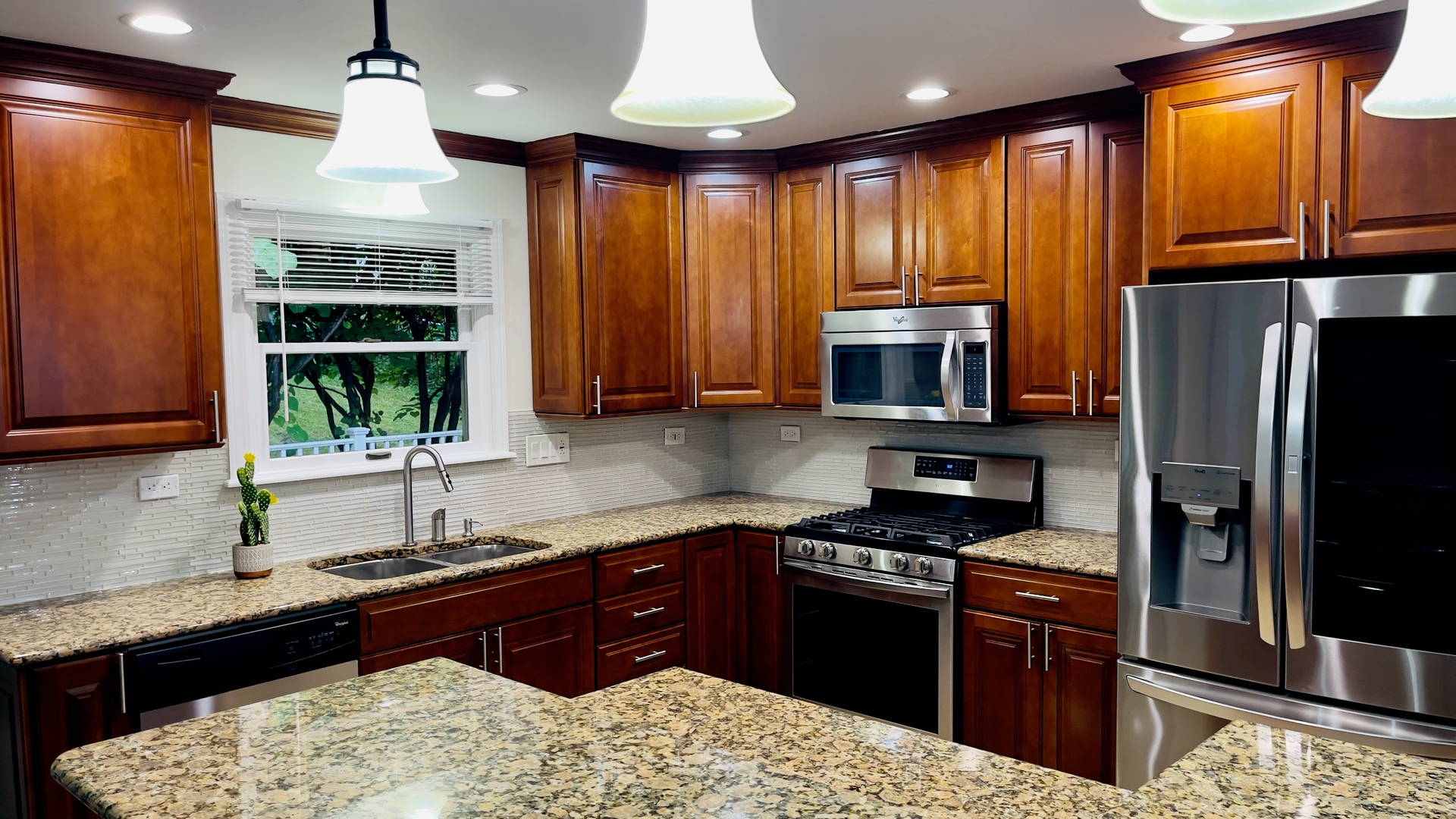902 Woodland Road Wauconda, IL 60084 - Photo 9 of 28 a kitchen with stainless steel appliances granite countertop a stove sink refrigerator and cabinets