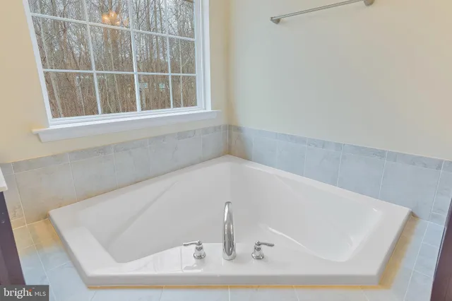 a bath tub sitting next to a window